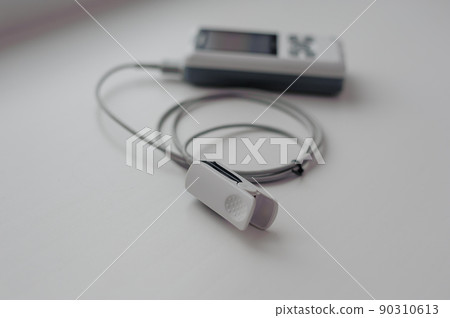 Pulse oximeter on a white background. Medical control and diagnostic device for measuring the saturation of capillary blood with oxygen 90310613