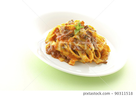 Bolognese with mint leaves, well entwined with flat pasta fitcine and tomato sauce Bolognese with mint leaves, well entwined with flat pasta fitcine and tomato sauce 90311518