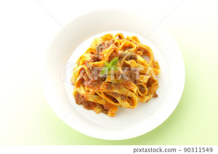 A bird's-eye view of Bolognese with mint leaves that are often entwined with flat pasta fitcine and tomato sauce. A bird's-eye view of Bolognese with mint leaves that are often entwined with flat pasta fitcine and tomato sauce. 90311549