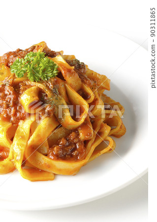Bolognese with flat pasta fitcine and tomato sauce often entwined on a white background 90311865