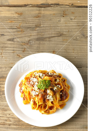 A bird's-eye view of Parmesan cheese on Bolognese, which is often entwined with flat pasta fitcine and tomato sauce. A bird's-eye view of Parmesan cheese on Bolognese, which is often entwined with flat pasta fitcine and tomato sauce. 90312226