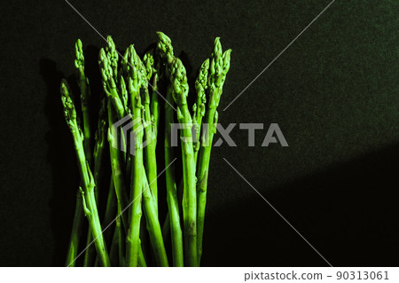 Green fresh asparagus isolated on black background. 90313061