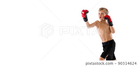 Little boy, kid in sports shots and gloves practicing thai boxing on white studio background. Sport, education, action, motion concept. 90314624