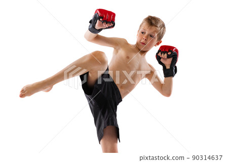 One little boy, sportive kid in black shots and gloves training thai boxing on white studio background. Sport, education, action, motion concept. 90314637