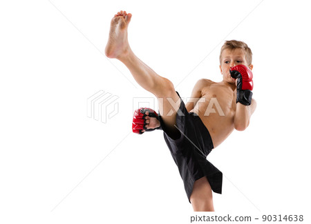 Beginner athlete, kid in sports shots and gloves practicing thai boxing on white studio background. Sport, education, action, motion concept. Beginner athlete, kid in sports shots and gloves practicing thai boxing on white studio background. Sport, education, action, motion concept. 90314638