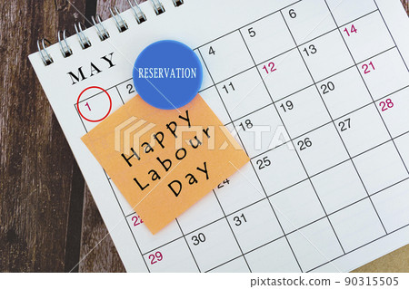 May calendar with date circle and text on sticky note and smile face magnet. 90315505