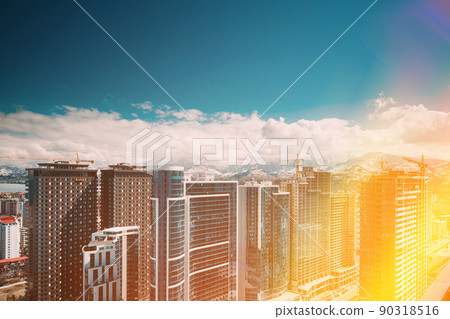 New Residential Multi-storey Houses On Blue Sky. Real Estate, Development Industry. highrise houses Elevated View Cityscape Skyline. Light Lighting. Industrial concept. Building industry 90318516