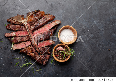 Grilled porterhouse beef steak. Sliced T-bone 90318598