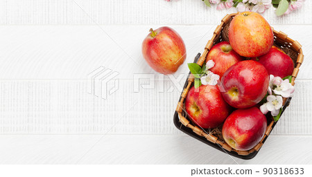 Ripe red apples and apple blossom flowers in basket 90318633