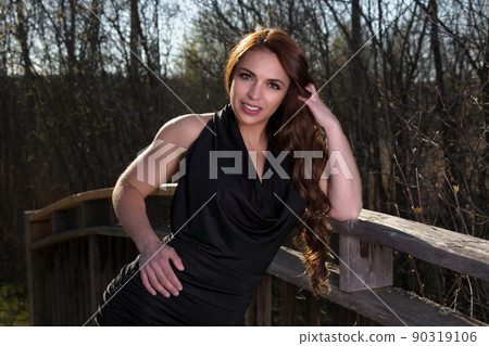 beautiful woman outdoor portrait elegance black dress at the park long hair brunette beautiful woman outdoor portrait elegance black dress at the park long hair brunette 90319106