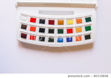 Watercolor paints on white background. Flat lay, top view Watercolor paints on white background. Flat lay, top view 90319606
