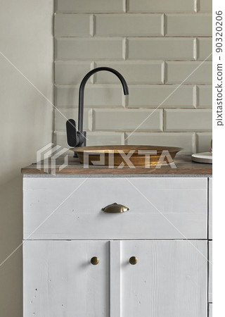 White cabinets with copper sink at kitchen counter residential house. White cabinets with copper sink at kitchen counter residential house. 90320206