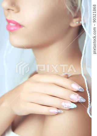 Hands with french manicure on a wedding dress. Hands with french manicure on a wedding dress. 90321868