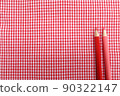 Red gingham check cloth and colored pencils 90322147