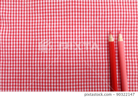 Red gingham check cloth and colored pencils 90322147