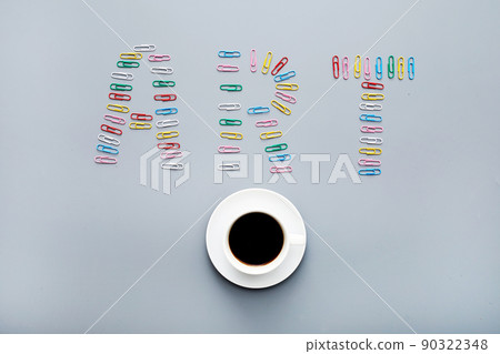 Modern art concept: directly above view of colorful paper clips laid out in shape of art inscription and coffee cup Modern art concept: directly above view of colorful paper clips laid out in shape of art inscription and coffee cup 90322348