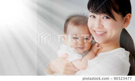 Mother hugging baby 90323477
