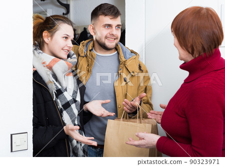 Smiling guy with wife visiting his mother Smiling guy with wife visiting his mother 90323971