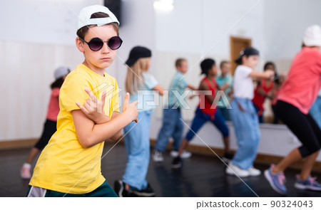 Tween boy hip hop dancer posing during group class 90324043