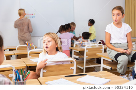Kids pupils talking during recess between lessons Kids pupils talking during recess between lessons 90324110