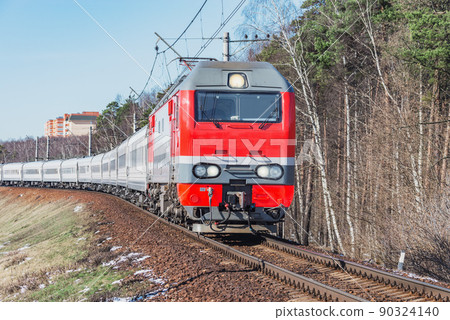 Passenger train moves at spring morning time. 90324140