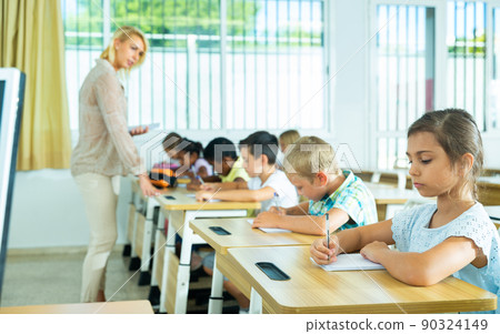 Group of focused kids working at class Group of focused kids working at class 90324149