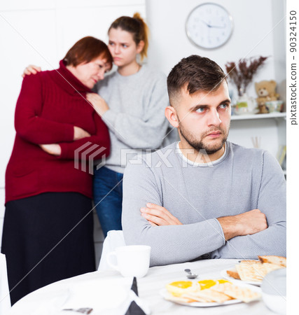 Upset guy after discord with mother and wife Upset guy after discord with mother and wife 90324150