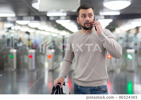 Portrait of man passing faregate on subway station 90324365