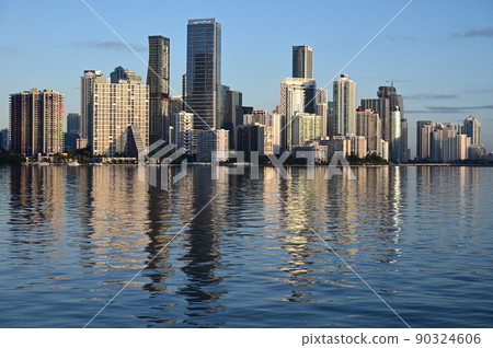 City of Miami, Florida skyline reflected in calm water of Biscayne Bay. City of Miami, Florida skyline reflected in calm water of Biscayne Bay. 90324606
