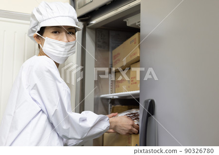 A woman wearing a lab coat and making a meal A woman wearing a lab coat and making a meal 90326780