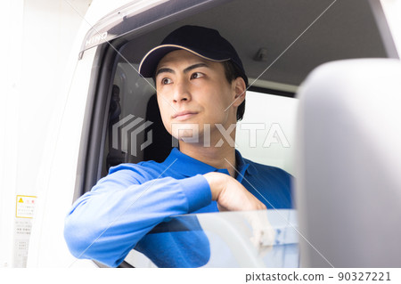 Delivery staff driving a truck 90327221