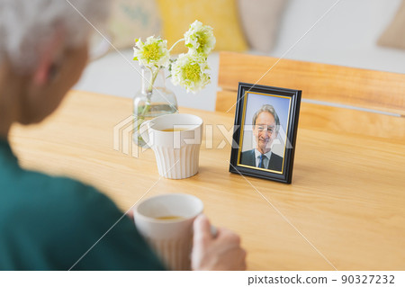 Senior woman having tea time with a man in the deceased 90327232