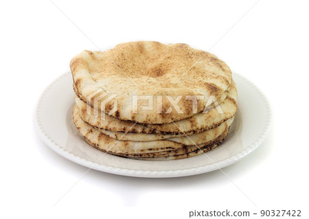 Pita bread isolated on white background in ceramic dish. Traditional food of Arabic cuisine Pita bread isolated on white background in ceramic dish. Traditional food of Arabic cuisine 90327422