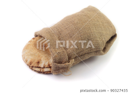 Pita bread isolated on white background of rustic fabric bag. Food of Arab cuisine Pita bread isolated on white background of rustic fabric bag. Food of Arab cuisine 90327435
