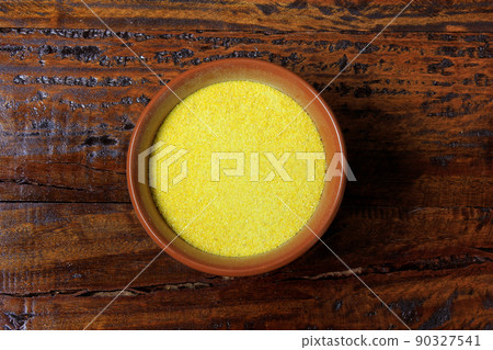 cassava flour inside ceramic pot on wooden table 90327541