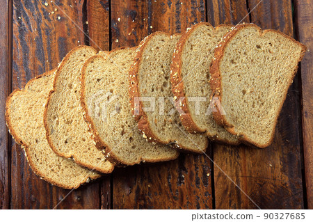 Wholegrain sliced organic bread composed of oats and flax seeds on wooden table. Healthy Diet 90327685