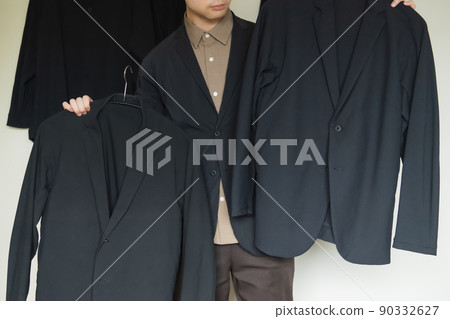 The upper body of a man who thinks about which jacket to wear The upper body of a man who thinks about which jacket to wear 90332627