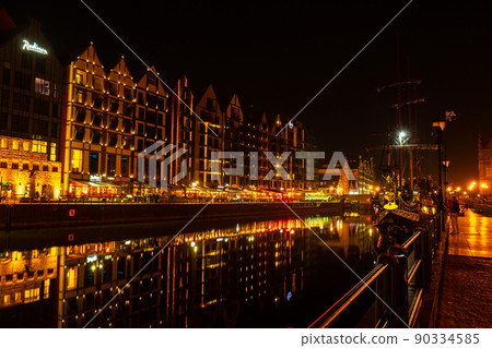 Old town in Gdansk at night. The riverside on Granary Island reflection in Moltawa River Cityscape at twilight. Ancient crane at dusk. Visit Gdansk Poland Travel destination Old town in Gdansk at night. The riverside on Granary Island reflection in Moltawa River Cityscape at twilight. Ancient crane at dusk. Visit Gdansk Poland Travel destination 90334585