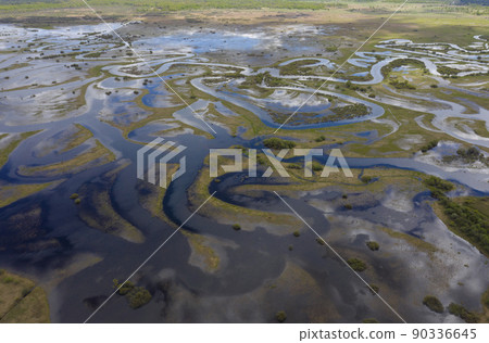 Aerial view of winding flooded river beds with ducts, during the spring flood. Aerial view of winding flooded river beds with ducts, during the spring flood. 90336645