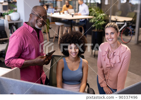 Portrait of happy multiracial businessman and businesswomen working together at modern workplace Portrait of happy multiracial businessman and businesswomen working together at modern workplace 90337496