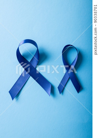 Close-up of blue stomach cancer awareness ribbons isolated on blue background, copy space 90338701