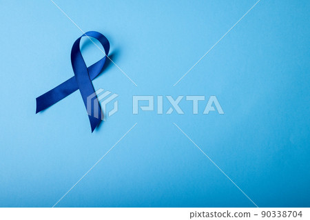 Directly above shot of blue stomach cancer awareness ribbon isolated on blue background, copy space Directly above shot of blue stomach cancer awareness ribbon isolated on blue background, copy space 90338704