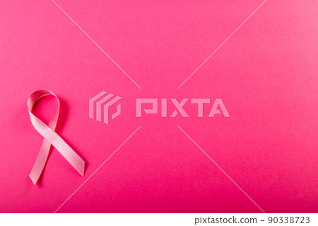 Directly above shot of breast cancer awareness pink ribbon isolated on pink background, copy space Directly above shot of breast cancer awareness pink ribbon isolated on pink background, copy space 90338723