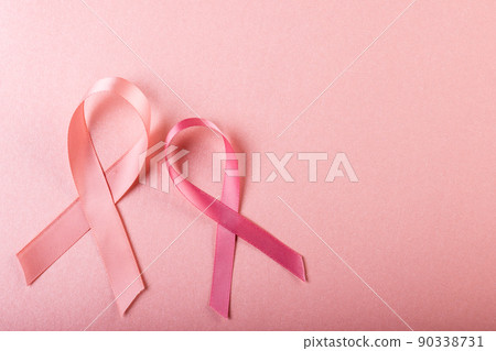 Directly above shot of breast cancer awareness pink ribbons against pink background, copy space 90338731