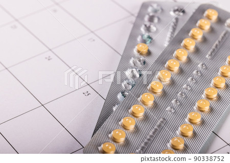 High angle close-up of medicine blister packs on medication calendar, copy space 90338752