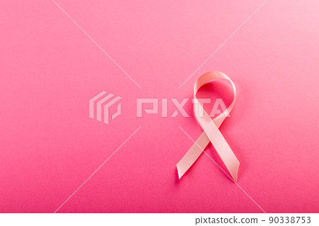 Directly above shot of breast cancer awareness pink ribbon isolated on pink background, copy space 90338753