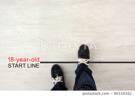 18-year-old adult start line and male feet 18-year-old adult start line and male feet 90339382