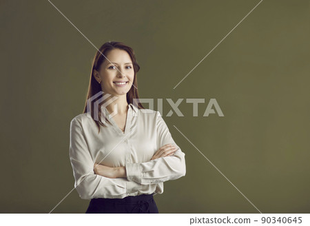 Portrait of smiling businesswoman on green background Portrait of smiling businesswoman on green background 90340645