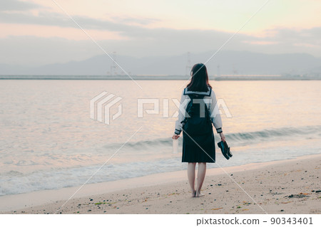 Schoolgirl in uniform and beautiful sunset sky Schoolgirl in uniform and beautiful sunset sky 90343401