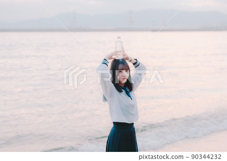 Schoolgirl in uniform and beautiful sunset sky Schoolgirl in uniform and beautiful sunset sky 90344232
